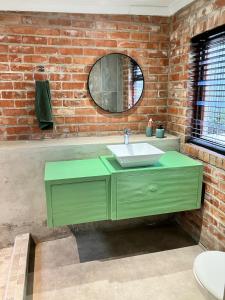 カーク・ベイにあるThe Lookout - Kalk Bayの緑の洗面台とレンガの壁があるバスルーム +31枚の写真