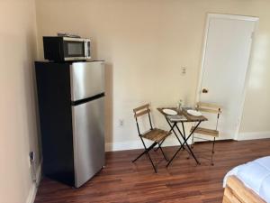 a kitchen with a refrigerator and a table with a microwave at Miami Spacious Executive Suite in Miami +10 photos