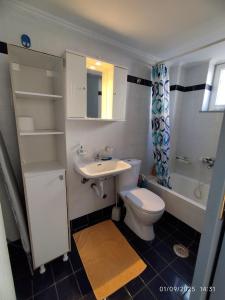 a bathroom with a toilet and a sink at CityRest in Preveza