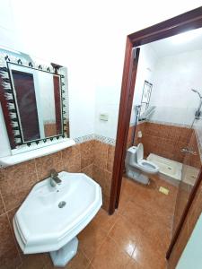 a bathroom with a sink and a toilet at Masa Nizwa ماسة نزوى in Nizwa