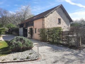 an old stone building with a gate in front of it at Gîte de l'Ane Papillon-3 chb- piscine-jardin in Saint-Cirq-Souillaguet