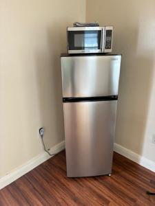 a silver refrigerator with a microwave on top of it at Miami Spacious Executive Suite in Miami