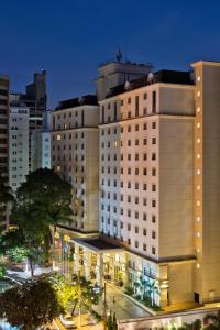 a view of a building in a city at night at Meliá Campinas in Campinas
