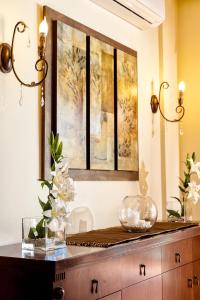 a dresser with a mirror and flowers on it at Villa Vallia - Villa Marina in Kato Galatas