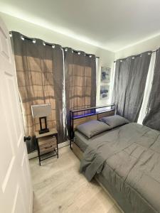a bedroom with a bed and a table with a lamp at Town & Country Andover NJ Area-1st Floor 2 Bedroom in Newton
