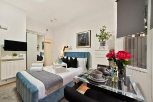 a hotel room with a bed and a table at Central Harrow 5 Studio Apartment Block in Harrow