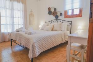 a bedroom with a bed with towels on it at Sea house of Candia in Kandia