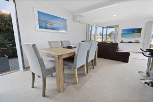 a dining room with a wooden table and chairs at Locanda in Paynesville +13 photos