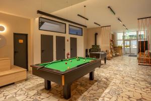 a large room with a pool table in it at The Cabin Retreat Piešťany 
