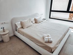 a bed with white sheets and pillows in a bedroom at Fee4me Exclusive Villa with Pool and Parking in Mutxamel +24 photos