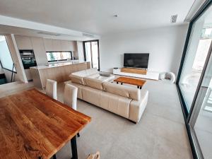 a living room with a couch and a table at Fee4me Exclusive Villa with Pool and Parking in Mutxamel