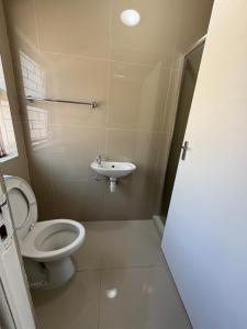 a bathroom with a toilet and a sink at Joy House in Cape Town