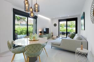 a living room with a table and a couch at Luxury Apartment Zen - by Welcomely in Platja de l'Arenal