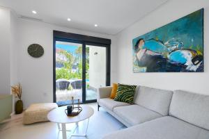 a living room with a couch and a painting on the wall at Luxury Apartment Zen - by Welcomely in Platja de l'Arenal