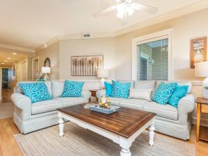 a living room with two couches and a coffee table at Brass Rail 317 in Tybee Island