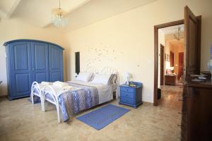 a bedroom with a bed and a blue cabinet at Al Canei B&B in Asti