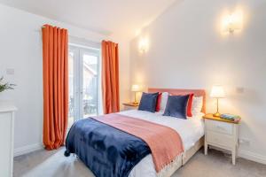 a bedroom with a bed and a window with orange curtains at 2 Bed in Church Fenton oc-m30985 in Church Fenton