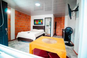 a bedroom with a bed and a table in a room at GREEN APARTMENT "El Jardín" in Girón