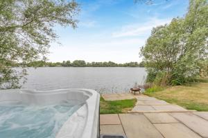 a bath tub sitting next to a body of water at 1 Bed in Langtoft oc-l32681 in Langtoft +9 photos
