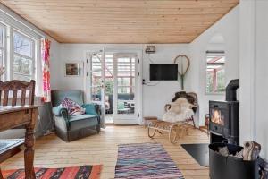 a living room with a fireplace and a wood stove at 4720-Ronne-Stampen-Vej-2-Hus-18 in Rønne
