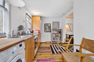 a kitchen with a sink and a washing machine at 4720-Ronne-Stampen-Vej-2-Hus-18 in Rønne +14 photos