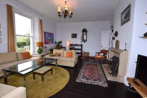 a living room with a couch and a table at 6 Bed in Branscombe oc-jbetco in Branscombe