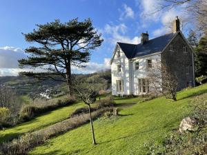 an old house on a hill with a tree at 6 Bed in Branscombe oc-jbetco in Branscombe