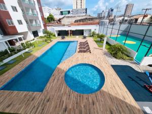 an overhead view of a swimming pool on top of a building at Belém COP30 Apartment in Belém