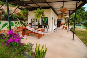 a porch with a hammock in a house at GREEN APARTMENT "el bosque" in Girón