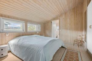 a bedroom with a bed and two windows at 6803-Allinge-Asbakken-20 in Allinge