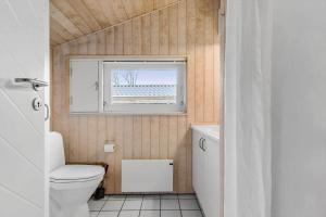 a bathroom with a toilet and a window at 6803-Allinge-Asbakken-20 in Allinge +14 photos
