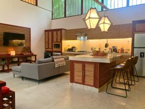 a kitchen and living room with a couch and a table at Uva Blue Villas - Pool House - AC, 3 bedrooms, 7 guests, Indoor pool with spill in Cocles