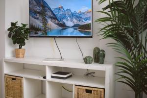 a living room with a tv on a wall at Brisa del Mar in Tacoronte