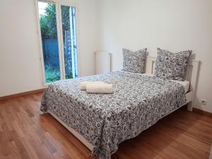 a bedroom with a bed with a large window at Charming 3 rooms with parking in Rueil-Malmaison