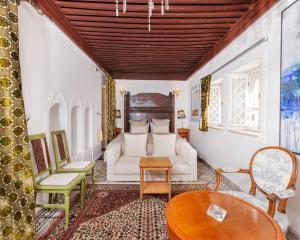 a living room with a couch and a table at Dar Tya Rabat Salé Marina in Sale