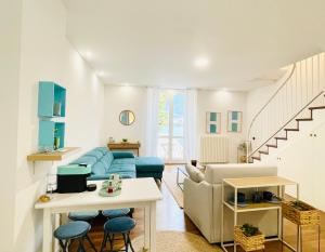a living room with a blue couch and a table at La finestra sul lago in Malgrate +35 photos