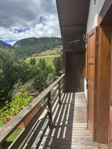 a wooden porch with a view of the mountains at Marcon ALPINA in Cojana