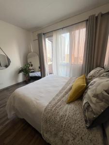 a bedroom with a bed and a large window at High Rise Haven in Johannesburg