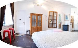a bedroom with a bed and two red chairs at Le petit carnot in Apt