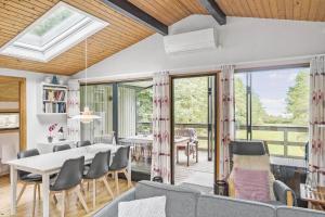 a dining room and living room with a table and chairs at 6780-Allinge-Gronnedalsvej-29 in Allinge