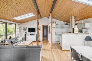 a living room and kitchen with a couch and a table at 6780-Allinge-Gronnedalsvej-29 in Allinge