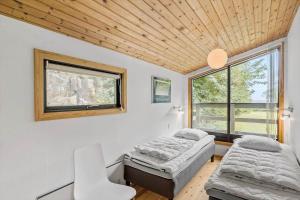 a room with two beds and a window at 6780-Allinge-Gronnedalsvej-29 in Allinge