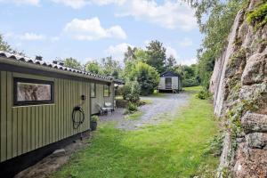 a couple of campsites next to a rock wall at 6780-Allinge-Gronnedalsvej-29 in Allinge +17 photos