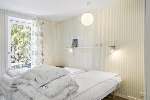 Postel nebo postele na pokoji v ubytování 3662-Nexo-Boulevarden-12