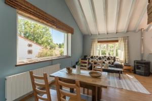 a living room with a table and a couch at Complejo Abiada Rural in Abiada +77 photos