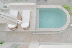 an aerial view of a swimming pool in a villa at Nour Uluwatu in Uluwatu
