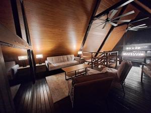 ein Wohnzimmer mit Sofas und einem Tisch in der Unterkunft Cabañas Piedra del Risco in Alto Boquete