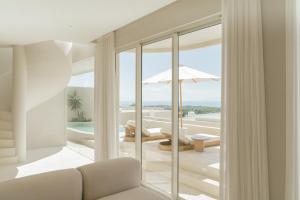 a living room with a view of the ocean at NOUR Uluwatu in Uluwatu