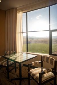 a room with a table and chairs and a large window at CAR Sport Hotel Titikaka in Huarina