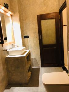 a bathroom with a sink and a toilet and a mirror at Coco Breeze Villa in Talpe +45 photos